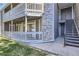 Close up shows the exterior of the condo with a stone accent wall and a balcony at 18105 E Ohio Ave # 104, Aurora, CO 80017