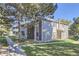 View of condo exterior with stone accents and mature trees offering shade and curb appeal at 18105 E Ohio Ave # 104, Aurora, CO 80017