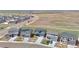An aerial view shows modern homes with driveways in a well-planned community near open green spaces at 6211 Bauer Dr, Frederick, CO 80504