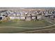 Aerial view of homes with fenced backyards next to open space at 6211 Bauer Dr, Frederick, CO 80504