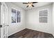 Bright bedroom with new ceiling fan, luxury vinyl plank flooring, and dual windows at 6211 Bauer Dr, Frederick, CO 80504