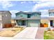 Two-story home featuring a clean, modern exterior, landscaped yard, and attached garage in a suburban neighborhood at 6211 Bauer Dr, Frederick, CO 80504