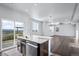 Kitchen island featuring a stylish faucet and granite countertops and access to the patio at 6211 Bauer Dr, Frederick, CO 80504