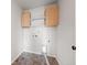 The laundry room has tile flooring, storage cabinets, and washer and dryer hookups at 6211 Bauer Dr, Frederick, CO 80504