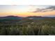 Panoramic aerial view of a wooded mountain range at sunset at 30717 Conifer Mountain Dr, Conifer, CO 80433