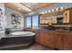 Bright bathroom with a soaking tub, dual sink vanity and scenic mountain view from the window at 30717 Conifer Mountain Dr, Conifer, CO 80433