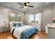 Serene bedroom featuring a bed with blue accents, hardwood floors, and windows offering beautiful natural outdoor views at 30717 Conifer Mountain Dr, Conifer, CO 80433