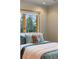 Cozy bedroom showcasing a comfortable bed with stylish pillows and a window offering a view of lush greenery at 30717 Conifer Mountain Dr, Conifer, CO 80433