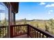 Exterior deck view overlooking lush green landscape and mountain views on a sunny day at 30717 Conifer Mountain Dr, Conifer, CO 80433