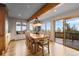 An open dining room features a wooden beam and walls of windows offering mountain views at 30717 Conifer Mountain Dr, Conifer, CO 80433