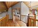 Spacious hallway featuring hardwood floors and wood trim, providing access to various rooms in the home at 30717 Conifer Mountain Dr, Conifer, CO 80433