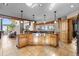 A large kitchen island is showcased in this kitchen with knotty wood cabinetry and granite countertops at 30717 Conifer Mountain Dr, Conifer, CO 80433