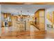Stylish open kitchen with natural wood cabinetry, a large island, and modern appliances at 30717 Conifer Mountain Dr, Conifer, CO 80433