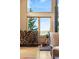 Cozy living room nook with a wood-burning stove, a stack of firewood, and scenic views at 30717 Conifer Mountain Dr, Conifer, CO 80433
