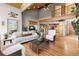 Bright, open living room with vaulted ceilings, hardwood floors, and access to a balcony at 30717 Conifer Mountain Dr, Conifer, CO 80433