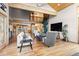 Bright and airy living room with stone fireplace, hardwood floors, and an open floor plan at 30717 Conifer Mountain Dr, Conifer, CO 80433