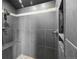 Modern tiled shower with rainfall shower head and built-in shelf with upscale finishes at 30717 Conifer Mountain Dr, Conifer, CO 80433