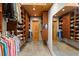 Spacious walk-in closet with custom wood shelves and storage for clothing, shoes and accessories at 30717 Conifer Mountain Dr, Conifer, CO 80433