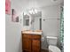 Well-lit bathroom featuring a single sink vanity, mirror, and tiled flooring at 1907 Windemere Ln, Erie, CO 80516