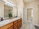 Bathroom features double sinks, a walk-in shower, and tiled flooring for a clean modern style at 1907 Windemere Ln, Erie, CO 80516