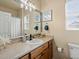 Bathroom features wood cabinetry, neutral countertops, and a single sink vanity with modern finishes at 1907 Windemere Ln, Erie, CO 80516