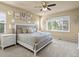 Neutral bedroom features a large window for natural light, plush carpet, and decorative wall art at 1907 Windemere Ln, Erie, CO 80516