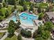 Aerial view of a vibrant community pool with slides, seating, and a spa at 1907 Windemere Ln, Erie, CO 80516