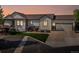 Charming home exterior with a well-manicured lawn and attached garage during sunset at 1907 Windemere Ln, Erie, CO 80516