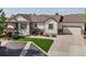 Inviting home with a well-kept lawn, stone accents, and an attached two car garage at 1907 Windemere Ln, Erie, CO 80516