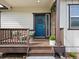 Cozy front porch with a stylish blue door and decorative accents at 1907 Windemere Ln, Erie, CO 80516