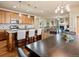 Open kitchen and living room space with granite counters, hardwood floors, and stainless steel appliances at 1907 Windemere Ln, Erie, CO 80516