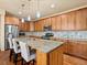 Spacious kitchen with wood cabinets, stainless steel appliances, and a large granite island at 1907 Windemere Ln, Erie, CO 80516