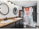 Bathroom featuring double sinks, stylish vanity, modern fixtures, and shower with decorative curtain at 1 N Pearl St # 102, Denver, CO 80203