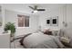 Bedroom features a ceiling fan, natural lighting, and neutral decor at 1 N Pearl St # 102, Denver, CO 80203