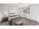 Bright bedroom featuring neutral walls, stylish lighting fixtures, comfortable furnishings, and a large window for ample natural light at 1 N Pearl St # 102, Denver, CO 80203