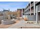 Courtyard with fountain, pergola, and seating area, surrounded by apartment buildings at 1 N Pearl St # 102, Denver, CO 80203