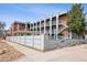 Exterior of apartment complex with private patios and metal privacy fence at 1 N Pearl St # 102, Denver, CO 80203