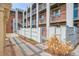 Apartment complex with brick facade and white metal fences, complemented by well-maintained landscaping at 1 N Pearl St # 102, Denver, CO 80203