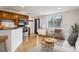 Open living area featuring hardwood floors, stainless steel appliances, and a bright sunny window at 1 N Pearl St # 102, Denver, CO 80203
