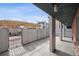 Private patio area with pergola, metal privacy fence, and neutral patio pavers at 1 N Pearl St # 102, Denver, CO 80203