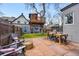 Relaxing backyard featuring a stone patio, cozy seating, and a unique treehouse, ideal for outdoor living and entertaining at 553 S Sherman St, Denver, CO 80209