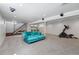 Finished basement with a staircase, a comfortable sofa, and exercise equipment for a functional space at 553 S Sherman St, Denver, CO 80209