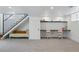 Finished basement with a staircase, a comfortable sofa, and a built-in desk area for studying or working at 553 S Sherman St, Denver, CO 80209