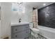 Charming bathroom featuring a gray vanity, stylish tile accents, and a shower-tub combination at 553 S Sherman St, Denver, CO 80209