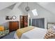 Charming bedroom featuring sloped ceilings, a skylight, and a vintage-style dresser at 553 S Sherman St, Denver, CO 80209
