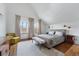 Bright bedroom features hardwood floors, a cozy sitting area, and large windows, offering a comfortable retreat at 553 S Sherman St, Denver, CO 80209
