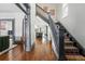 Grand entryway with hardwood floors, a decorative staircase, and views into the modern kitchen, creating a welcoming ambiance at 553 S Sherman St, Denver, CO 80209