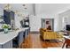 Inviting living room and kitchen featuring hardwood floors, lots of natural light, and open staircase at 553 S Sherman St, Denver, CO 80209