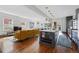 Open-concept living room featuring hardwood floors, lots of natural light, and modern kitchen island at 553 S Sherman St, Denver, CO 80209