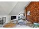 Inviting living room featuring exposed brick, comfortable seating, and a cozy nook with natural light at 553 S Sherman St, Denver, CO 80209